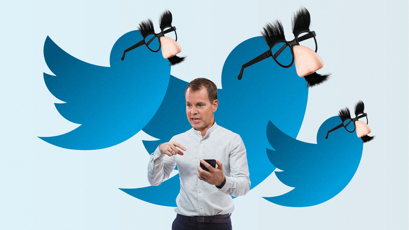 Casey Bloys in front of 3 blue Twitter birds with Groucho Marx-style nose and glasses on
